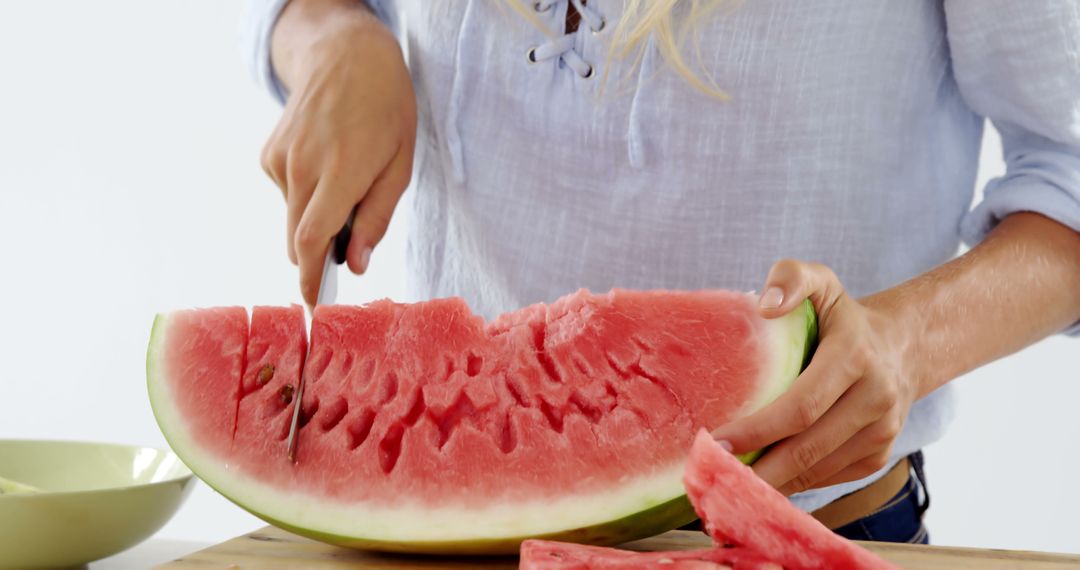 Person Slicing Fresh Watermelon on Cutting Board - Free Images, Stock Photos and Pictures on Pikwizard.com