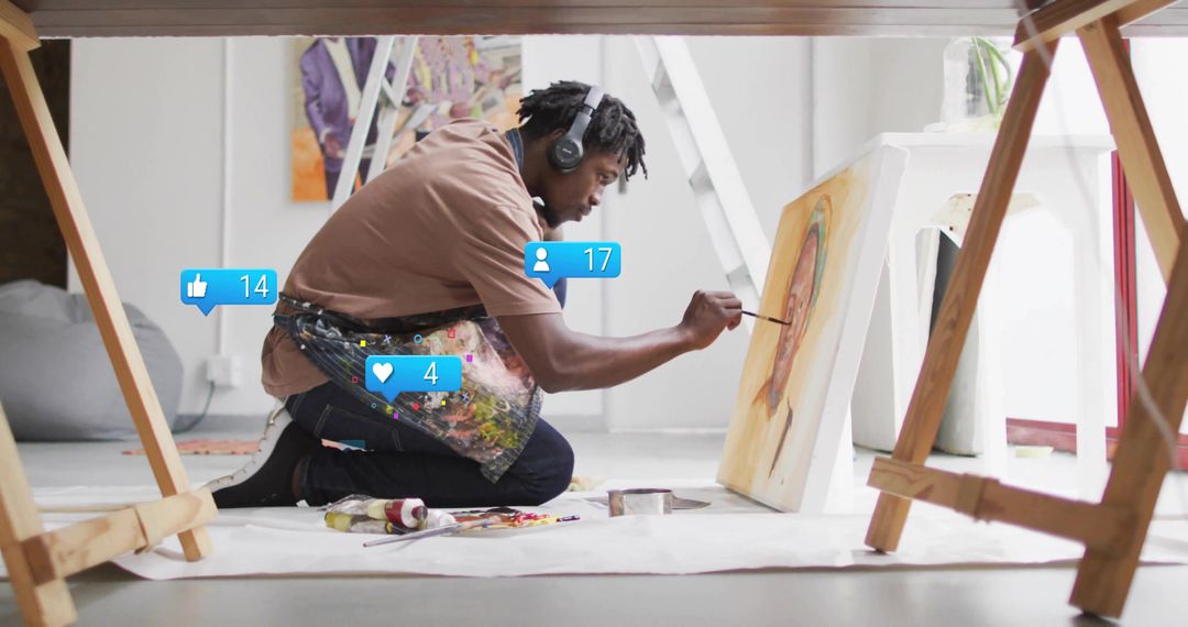 Kneeling Artist Painting on Canvas in Contemporary Studio