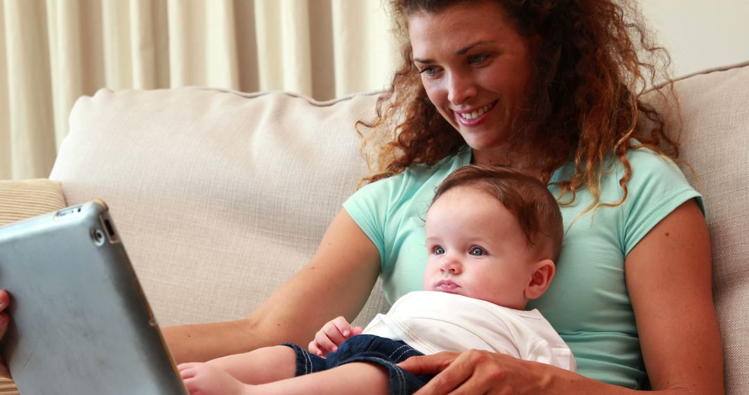 Smiling Mother Holding Baby while Using Digital Tablet - Free Images, Stock Photos and Pictures on Pikwizard.com