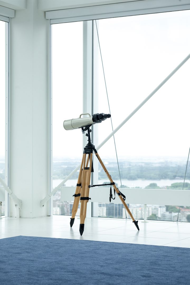 Telescope by Modern Window with Cityscape View - Free Images, Stock Photos and Pictures on Pikwizard.com