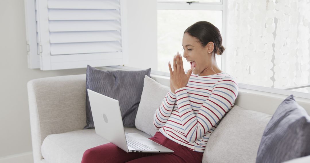 Excited Woman Using Laptop on Sofa at Home - Free Images, Stock Photos and Pictures on Pikwizard.com