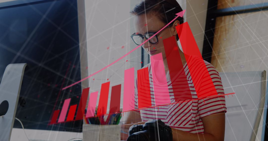 Woman Analyzing Data with Financial Graph Overlay at Office Desk - Free Images, Stock Photos and Pictures on Pikwizard.com