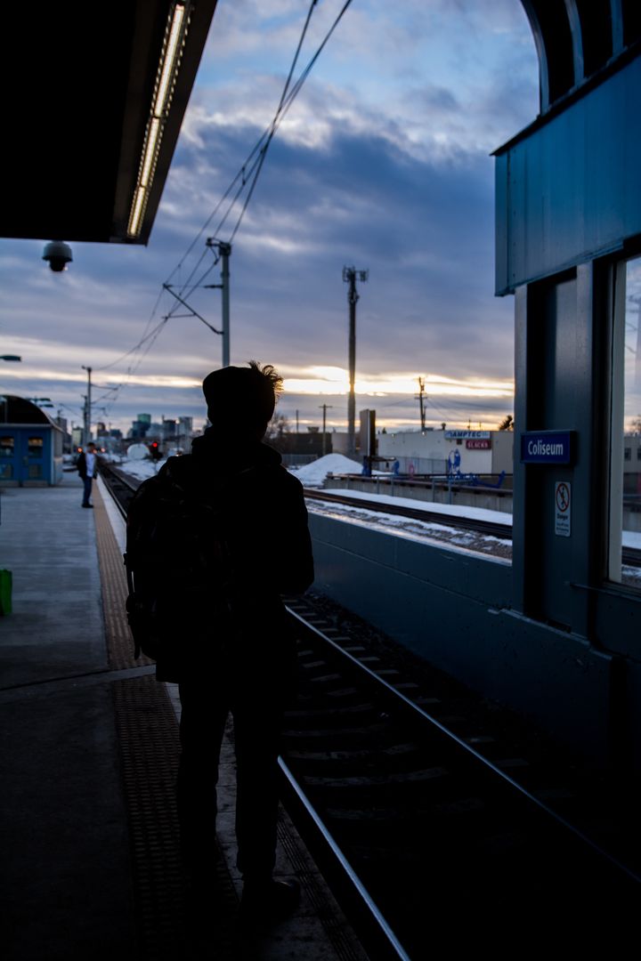 Silhouette of Traveler Waiting at Train Station at Sunset - Free Images, Stock Photos and Pictures on Pikwizard.com