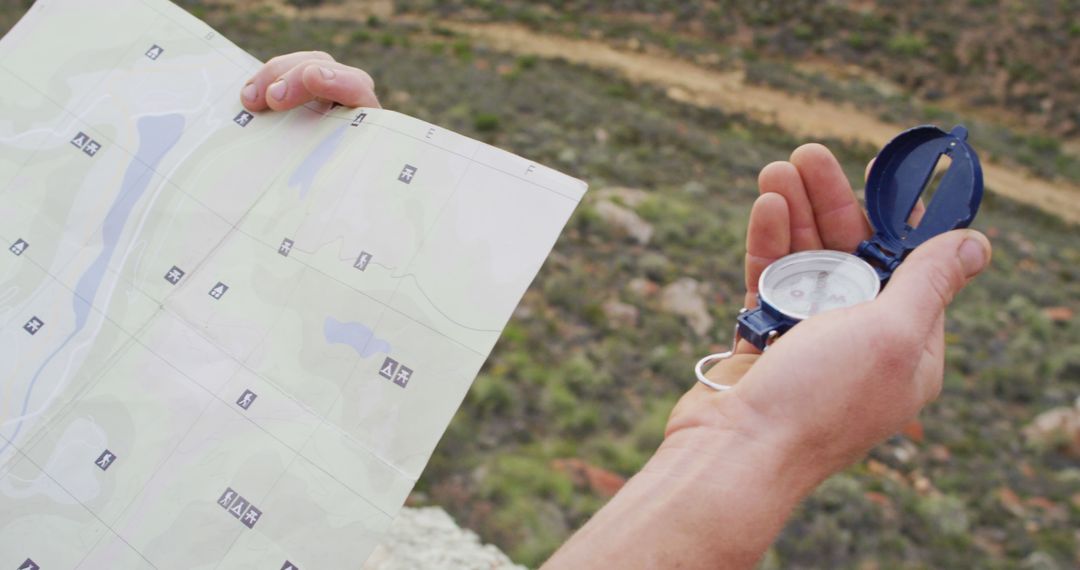 Hands Holding Map and Compass in Outdoor Adventure Setting - Free Images, Stock Photos and Pictures on Pikwizard.com