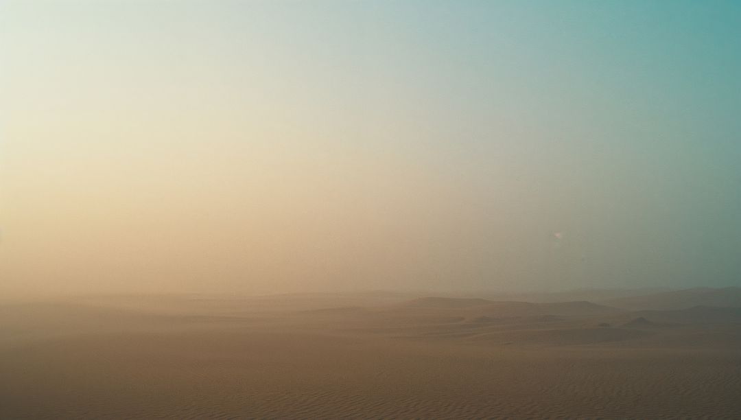 Vast and Serene Desert Dunes Under Clear Sky