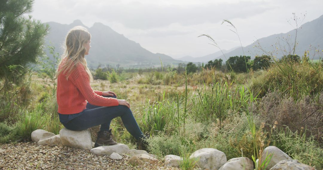 Woman Sitting Outdoors in Mountainous Landscape - Free Images, Stock Photos and Pictures on Pikwizard.com