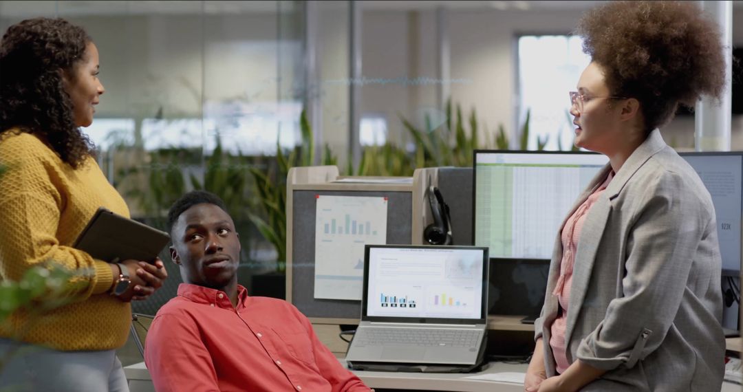 Diverse Team Discussing Digital Data in Modern Office Setting