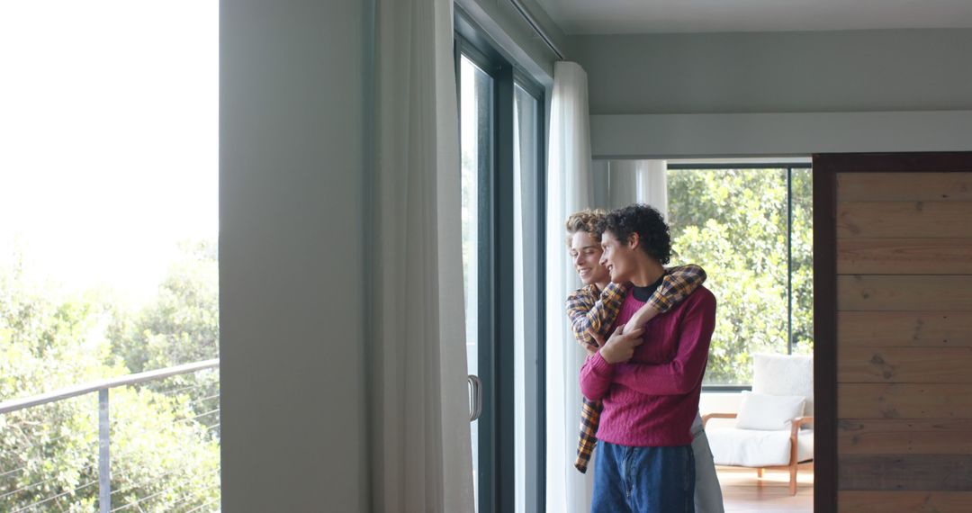 Happy Gay Couple Embracing and Enjoying Scenic View at Home