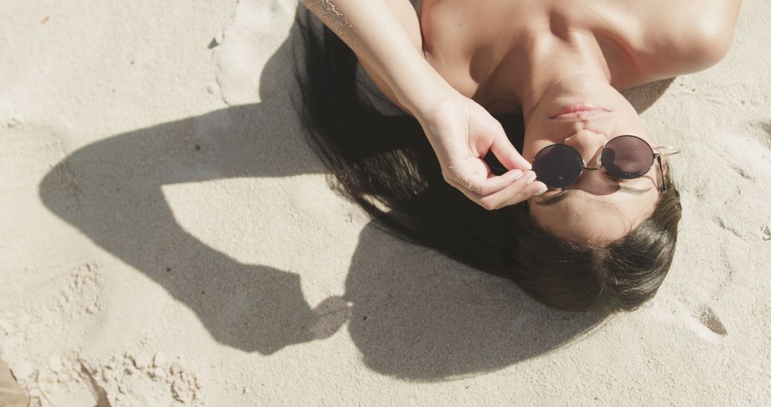 Woman Relaxing on Beach with Sunglasses - Free Images, Stock Photos and Pictures on Pikwizard.com