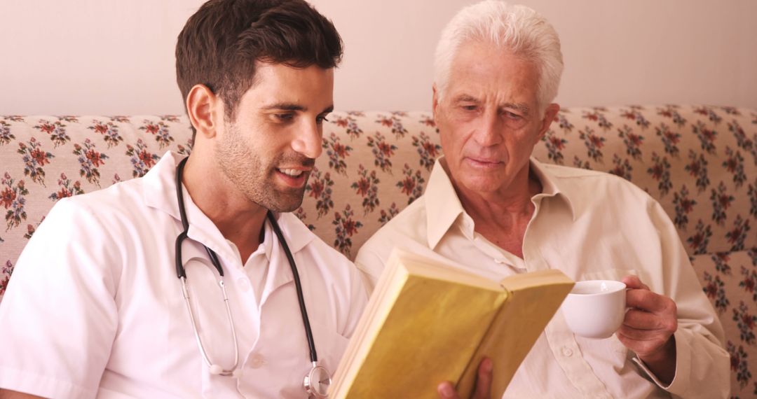 Young Doctor Reading Book with Elderly Patient at Home - Free Images, Stock Photos and Pictures on Pikwizard.com