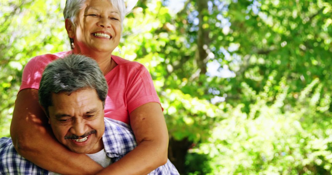Happy Senior Couple Embracing in Lush Park