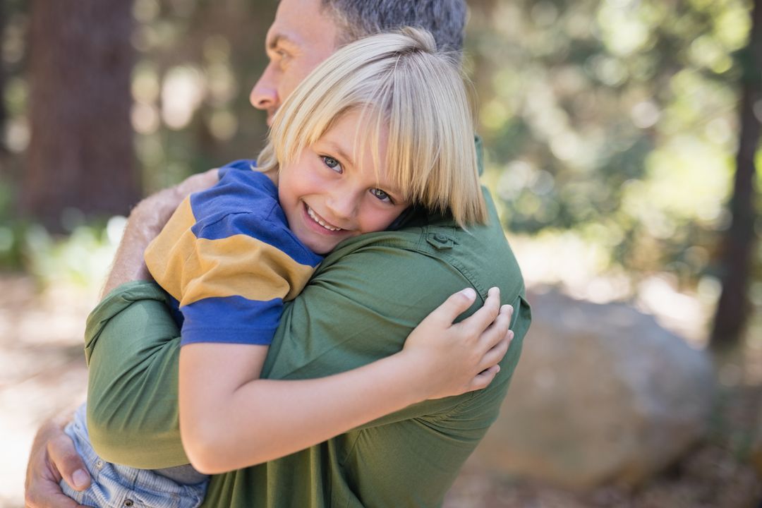 Smiling Boy Hugging Father in Forest - Free Images, Stock Photos and Pictures on Pikwizard.com