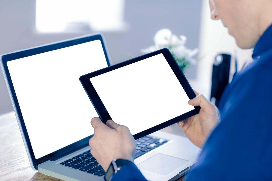 Businessman Engaging with Transparent Tablet and Laptop