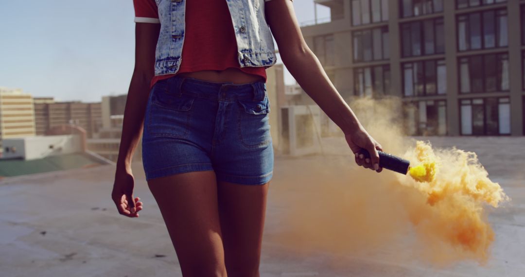 Young Woman Holding Smoke Bomb on Rooftop in Urban Area - Free Images, Stock Photos and Pictures on Pikwizard.com