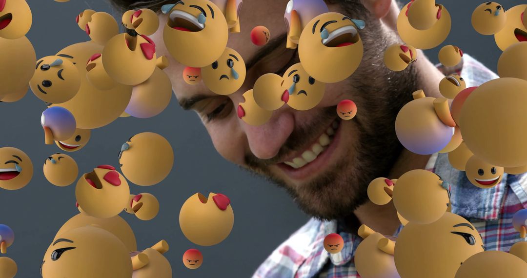 Smiling Man Surrounded by Floating 3D Emojis in Creative Digital Scene