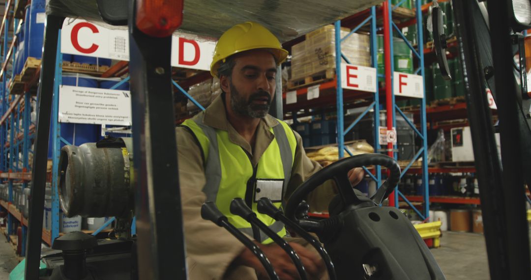 Warehouse Worker Operating Forklift in Industrial Storage Facility - Free Images, Stock Photos and Pictures on Pikwizard.com