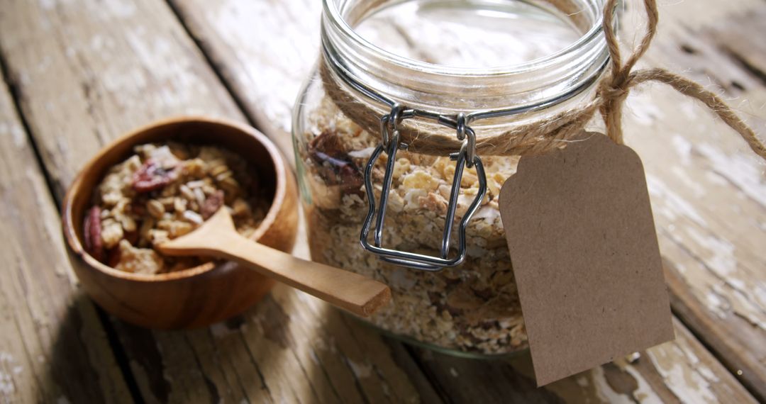 Homemade Granola in Glass Jar with Wooden Bowl on Rustic Table - Free Images, Stock Photos and Pictures on Pikwizard.com