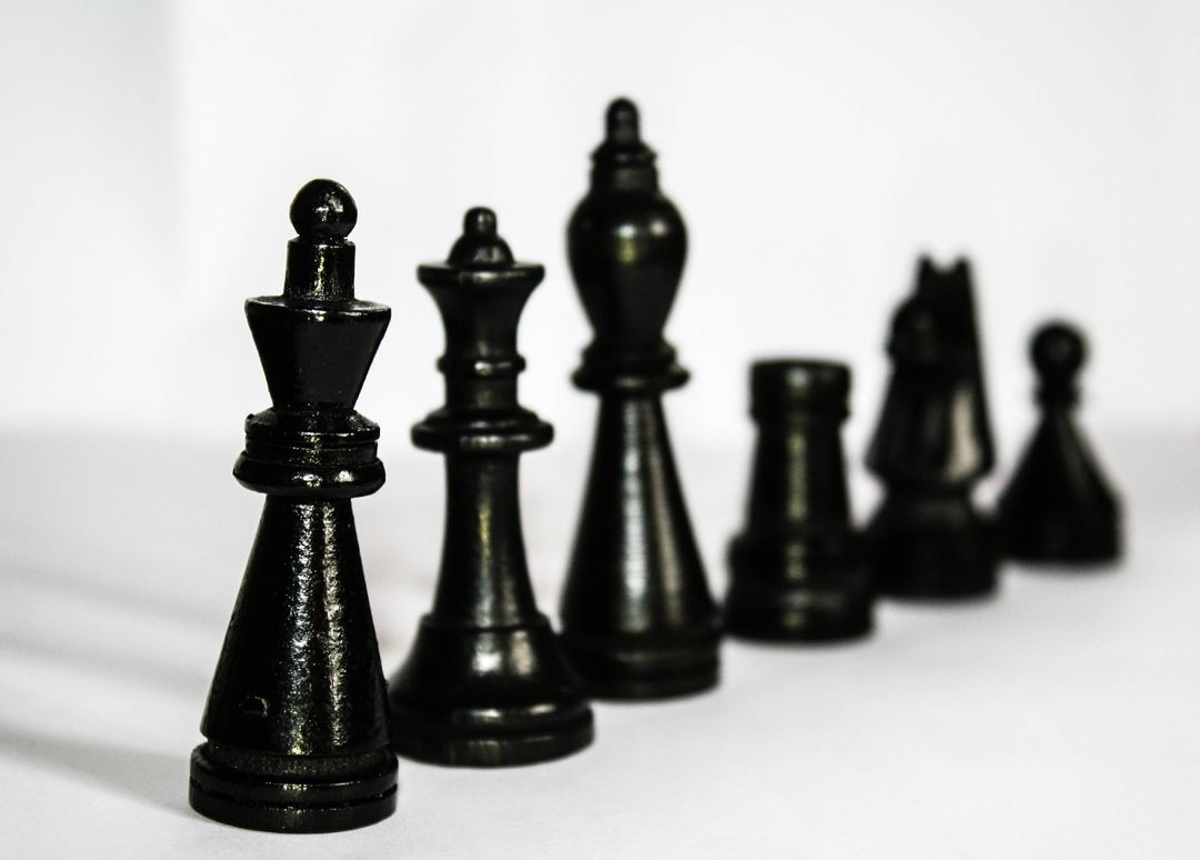 Close-up of Black Chess Pieces on White Background - Free Images, Stock Photos and Pictures on Pikwizard.com