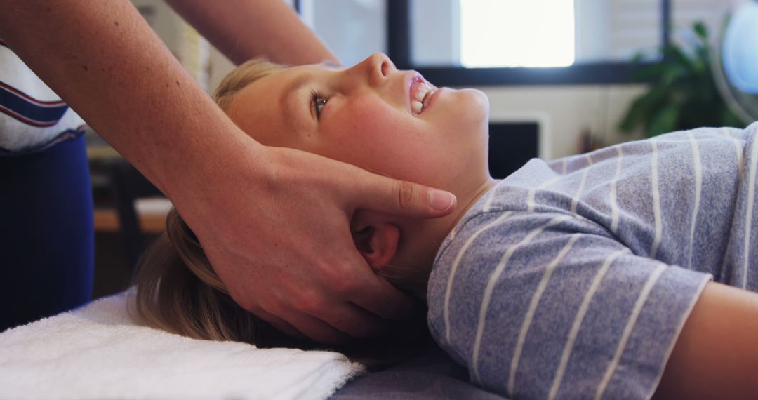 Young Boy Receiving Gentle Head Massage - Free Images, Stock Photos and Pictures on Pikwizard.com