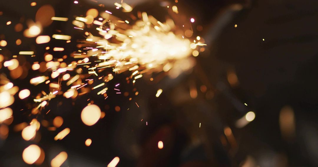 Orange sparks streaming across dark workshop, ember streaks and industrial bokeh motion