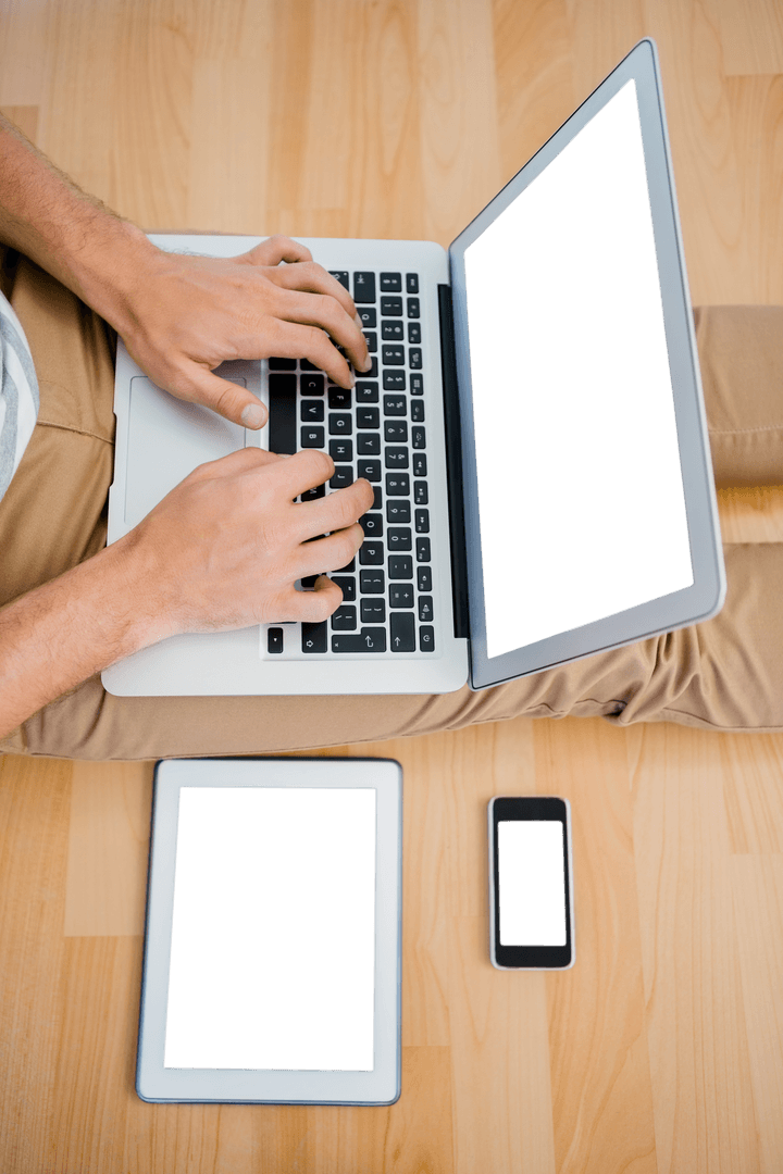 Transparent Overhead View Hands Typing on Laptop with Devices Nearby