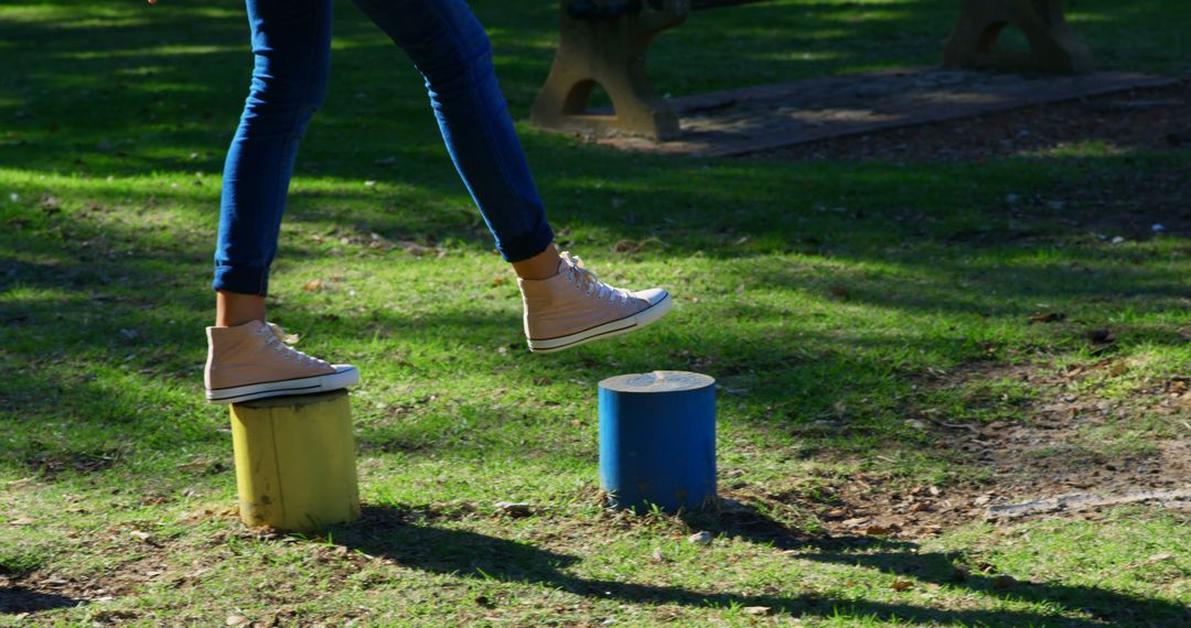 Person Balancing on Colorful Park Stumps - Free Images, Stock Photos and Pictures on Pikwizard.com