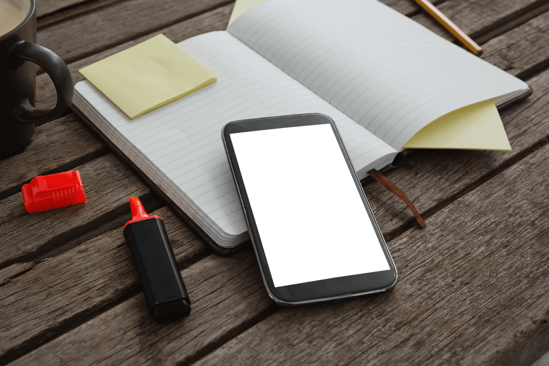 Transparent Mobile Phone on Wooden Plank with Notebook and Pen