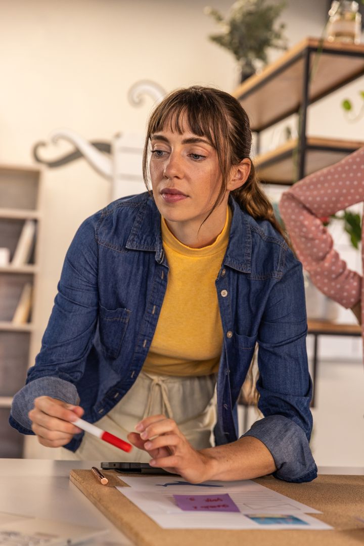 Focused Woman Collaborating in Modern Workspace on Creative Project