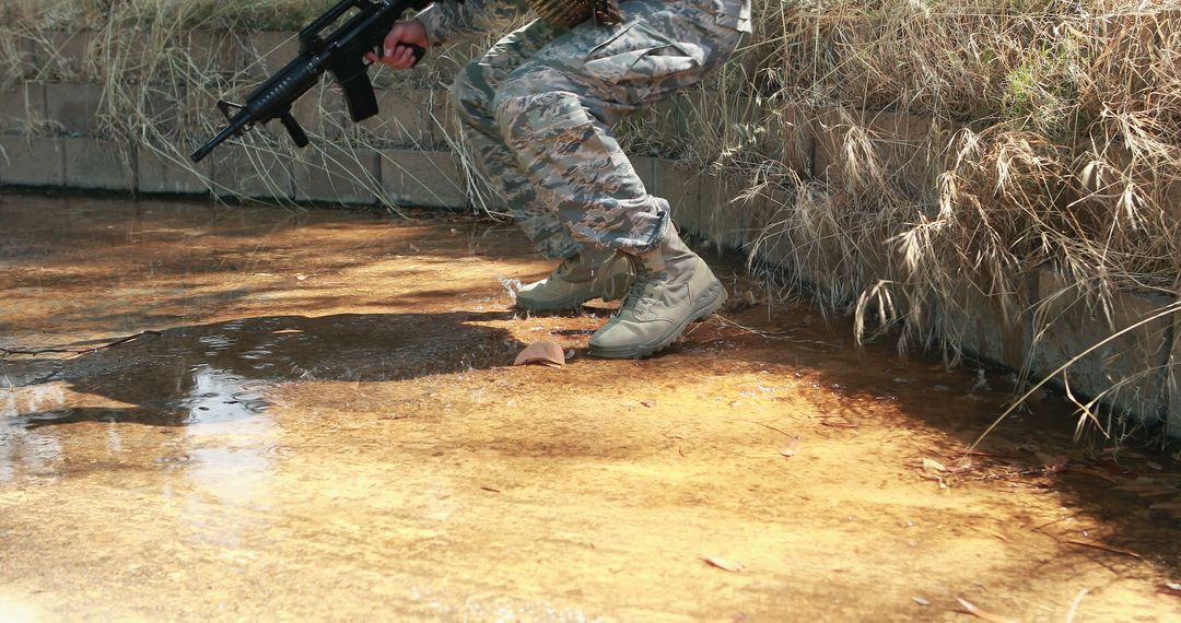 Soldier Navigating Shallow Water Challenge in Military Exercise