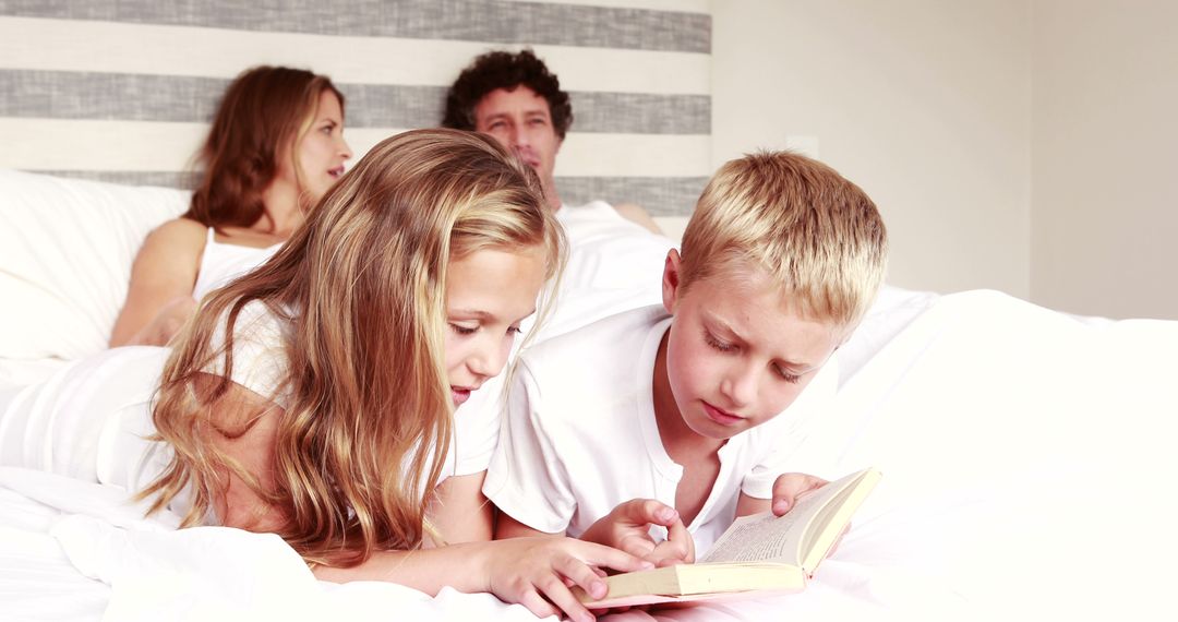 Happy Family Relaxing in Bed While Children Read Together - Free Images, Stock Photos and Pictures on Pikwizard.com