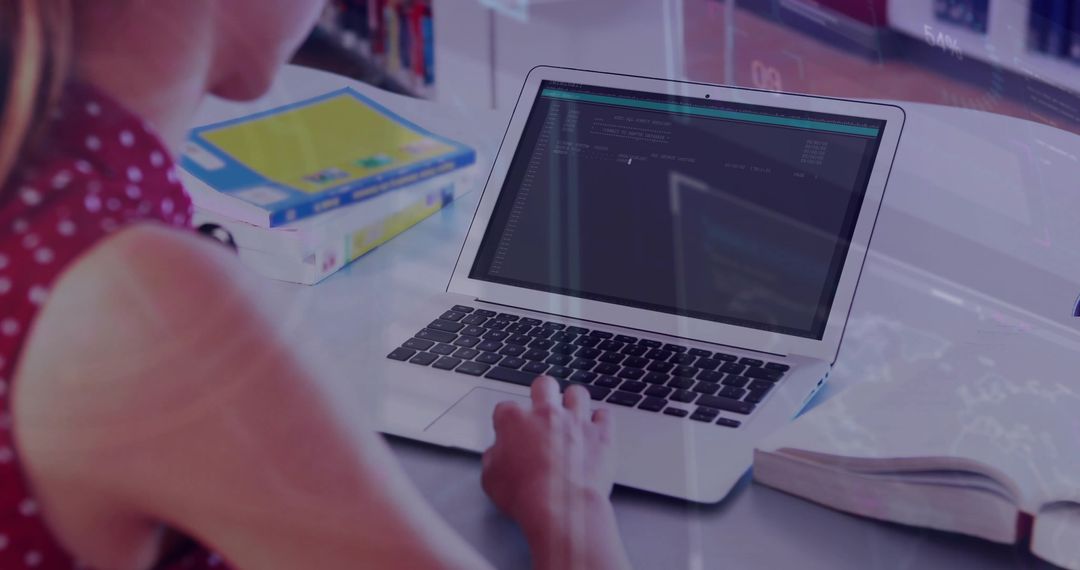 Young Woman Coding on Laptop in Library Workspace with Books and Notebook