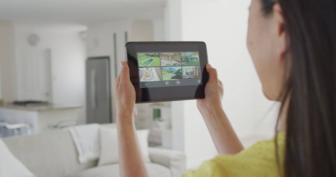 Woman Using Tablet to Control Home Security System - Free Images, Stock Photos and Pictures on Pikwizard.com