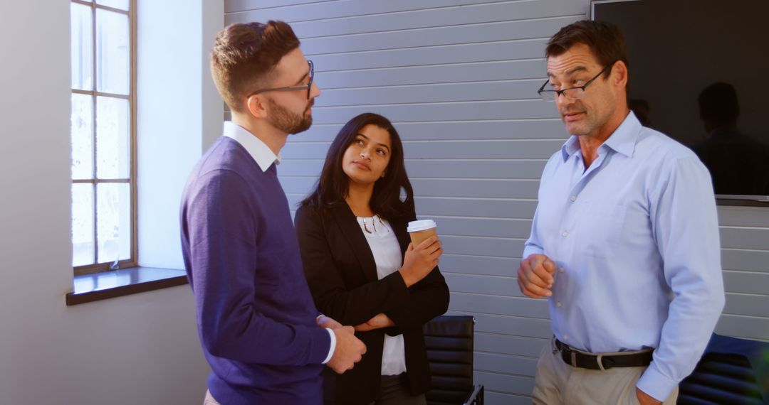 Diverse Professionals Engaged in Serious Office Discussion
