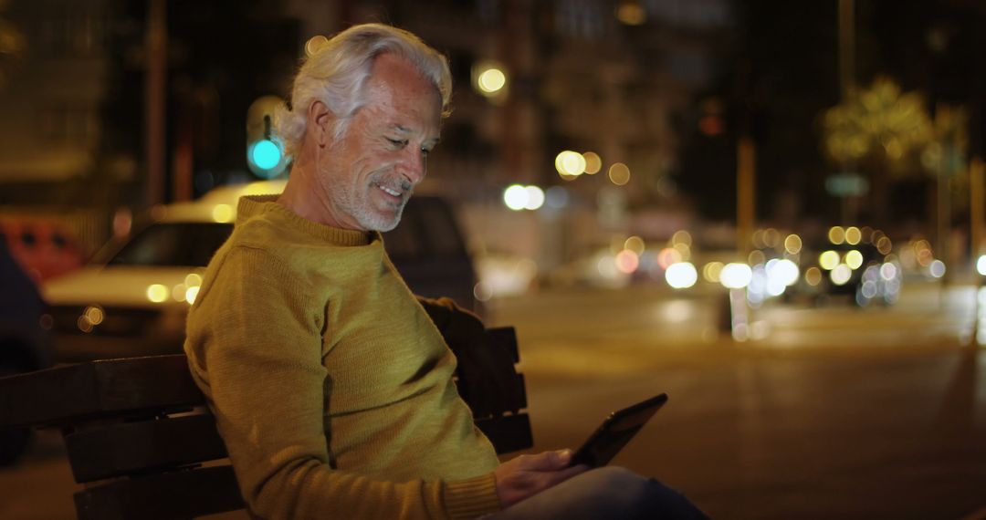 Senior Man Using Tablet on Park Bench at Night - Free Images, Stock Photos and Pictures on Pikwizard.com