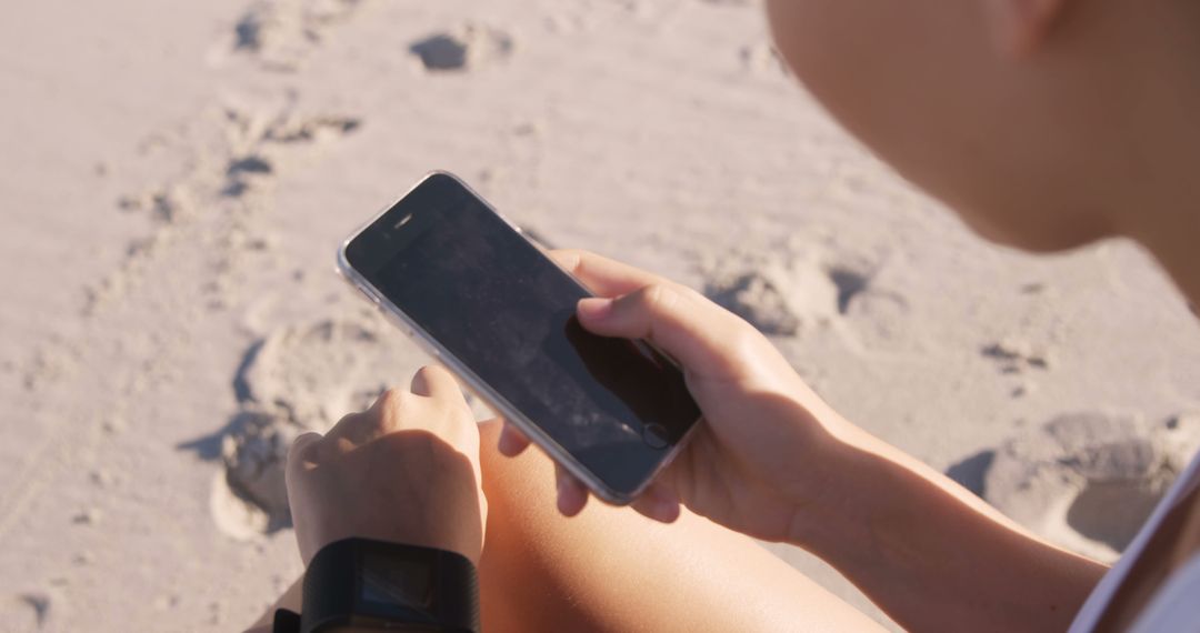 Person Checking Smartphone on Sunny Beach - Free Images, Stock Photos and Pictures on Pikwizard.com