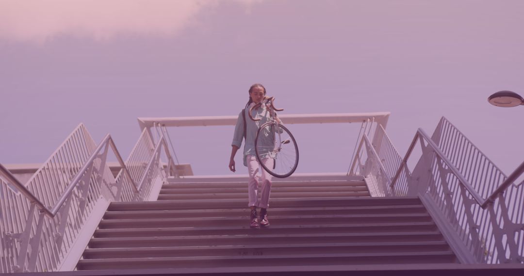 Man Carrying Bicycle Downstairs in Urban Environment