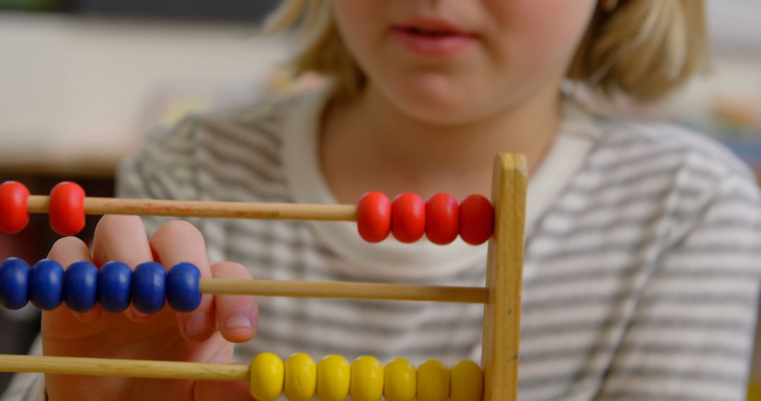 Caucasian Girl Using Abacus for Learning Mathematics in Classroom