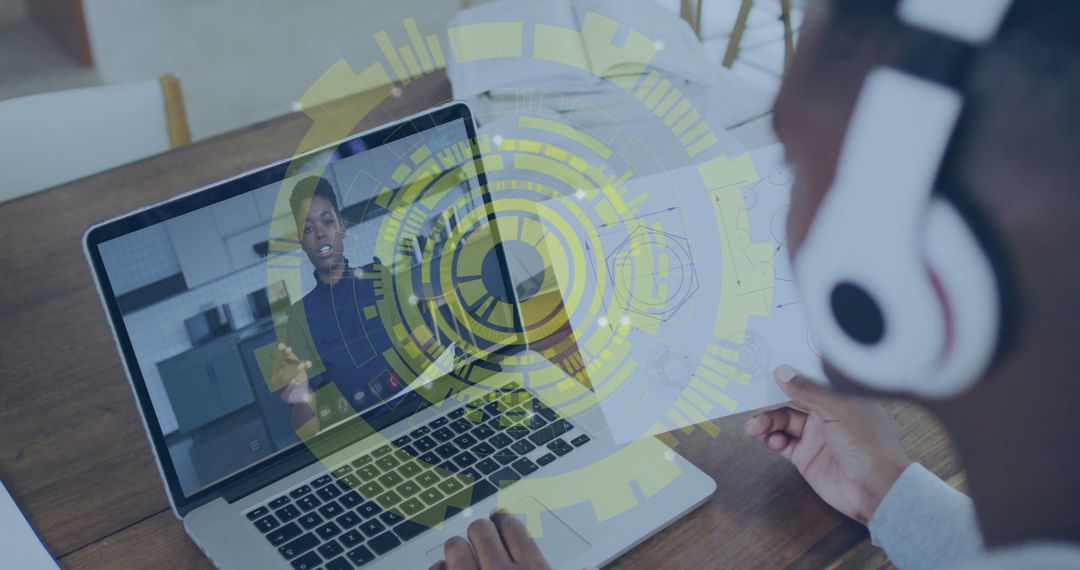 Architect Collaborating Online Using Laptop and Headphones