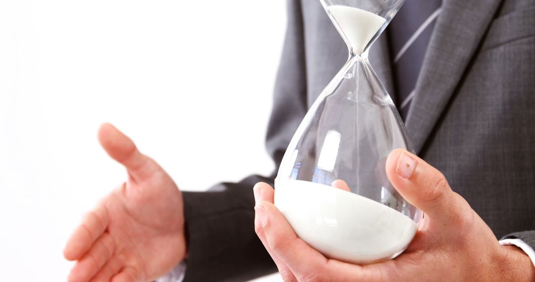 Businessman Holding Hourglass for Time Management Concept - Free Images, Stock Photos and Pictures on Pikwizard.com