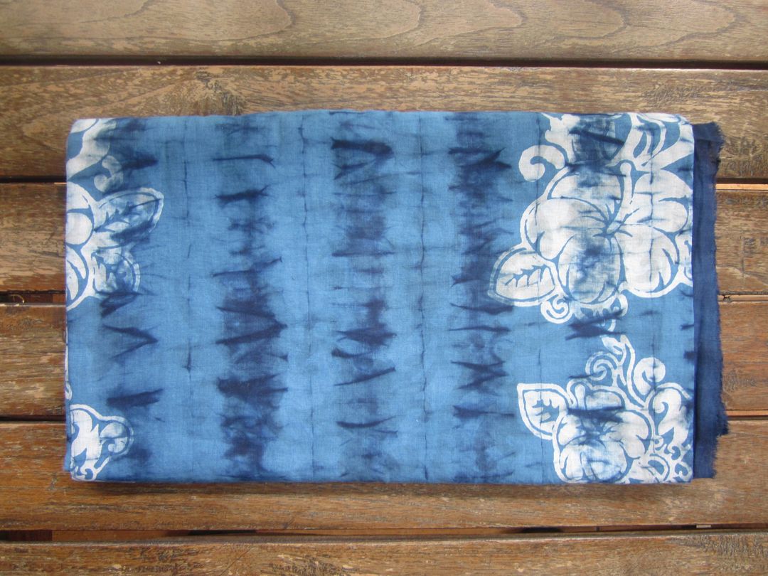 Blue Tie-Dye Cloth with White Floral Patterns on Wooden Surface - Free Images, Stock Photos and Pictures on Pikwizard.com