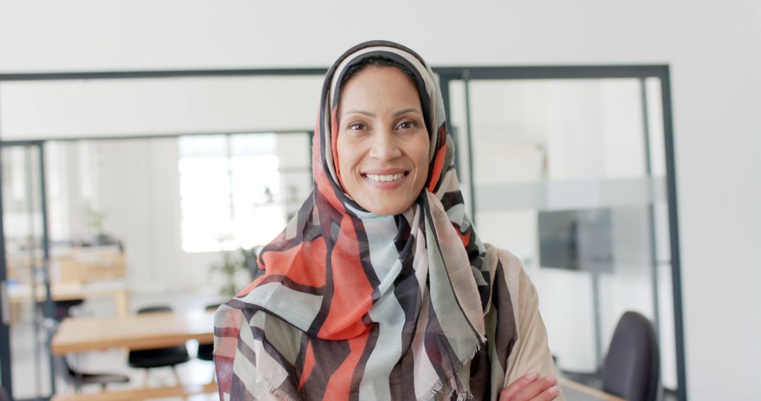 Confident Muslim Businesswoman Smiling in Modern Office - Free Images, Stock Photos and Pictures on Pikwizard.com