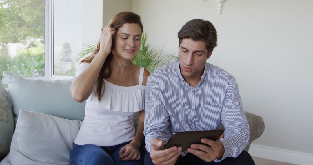 Couple Viewing Tablet Together in Cozy Living Room