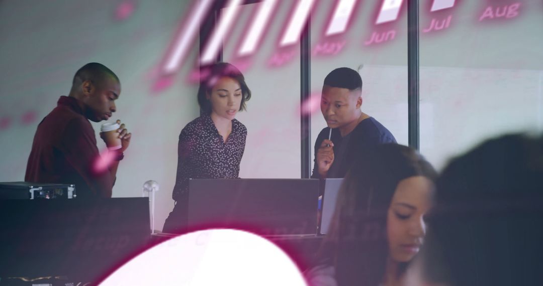 Multicultural Team Analyzing Data in Modern Office