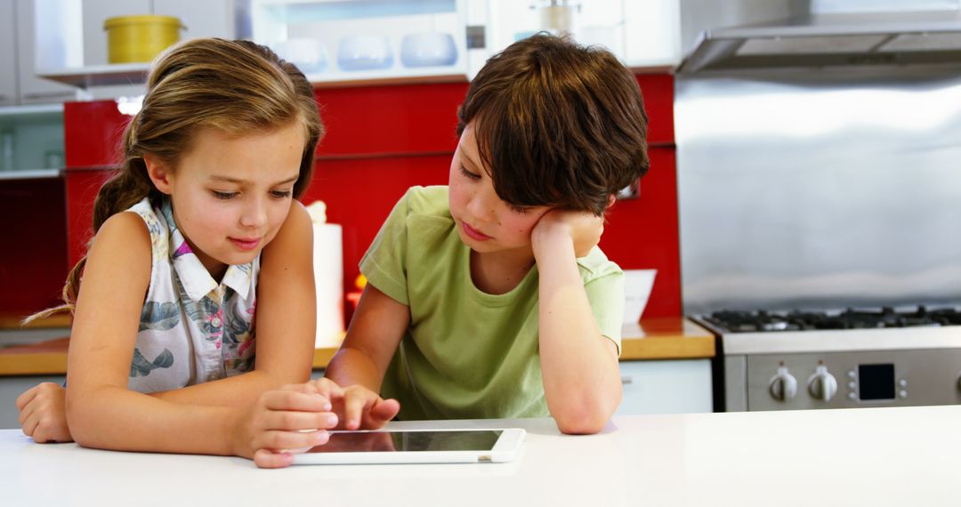 Two Young Children Using Digital Tablet in Modern Kitchen - Free Images, Stock Photos and Pictures on Pikwizard.com