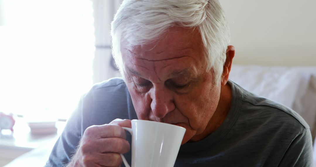 Senior Man Enjoying Morning Coffee in Bedroom - Free Images, Stock Photos and Pictures on Pikwizard.com