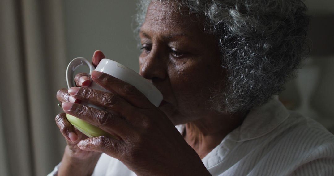 Elderly Woman Drinking Warm Beverage at Home - Free Images, Stock Photos and Pictures on Pikwizard.com