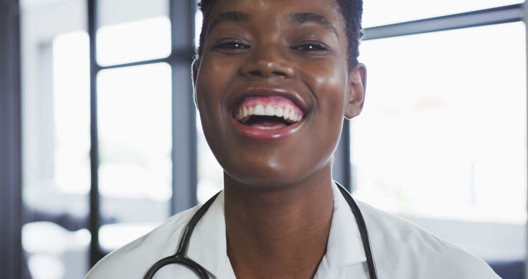 Smiling African American Female Doctor in Hospital with Stethoscope - Free Images, Stock Photos and Pictures on Pikwizard.com