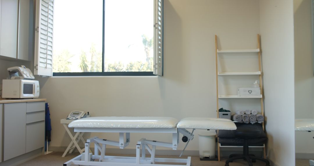 Bright Medical Examination Room with Empty Treatment Table