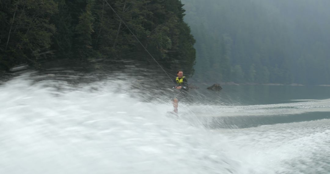 Person Wakeboarding on Lake with Dense Forest Background - Free Images, Stock Photos and Pictures on Pikwizard.com