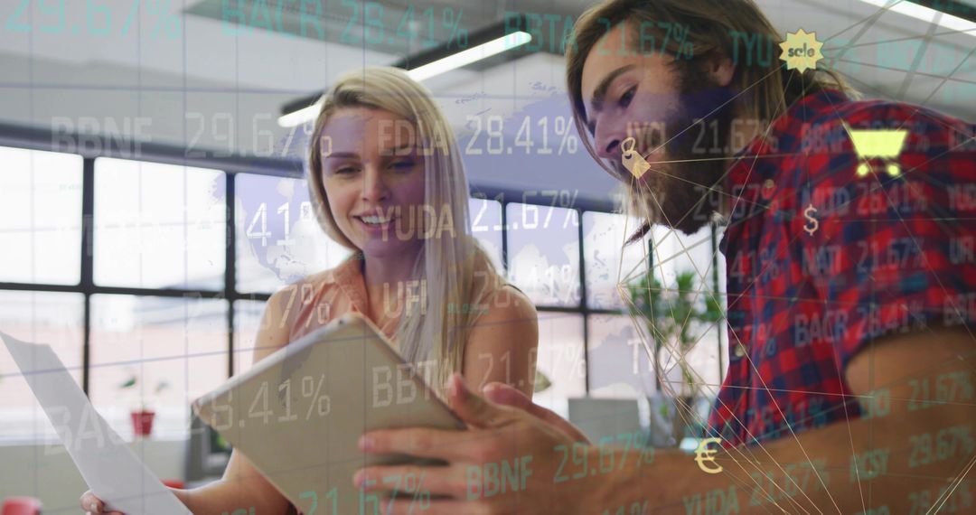 Coworkers Collaborating with Technology in Modern Open Office